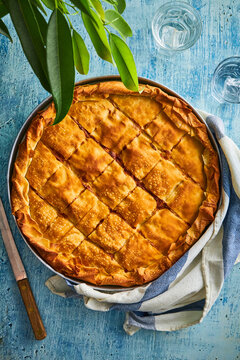 baking tray with meat pie on a blue background
