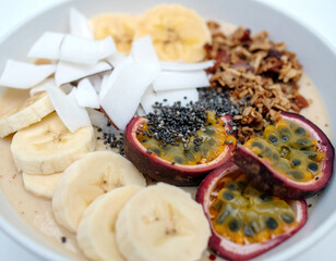 Healthy fresh banana, and passionfruit. with yoghurt in bowl. 