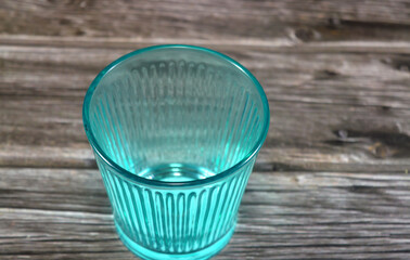 colorful ribbed glass container, the ribbed or the grooved pattern creates a visual effect especially when light passes through it, it can be used in several purposes like holding candles and drinks