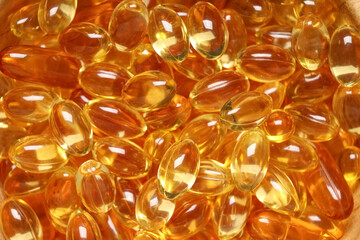 Vitamin E pills as background, closeup