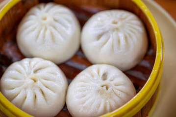 Delicious baozi served in a bamboo steamer