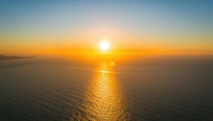 Fototapeta premium A golden sunrise illuminating the ocean surface, showcasing the tranquility of nature