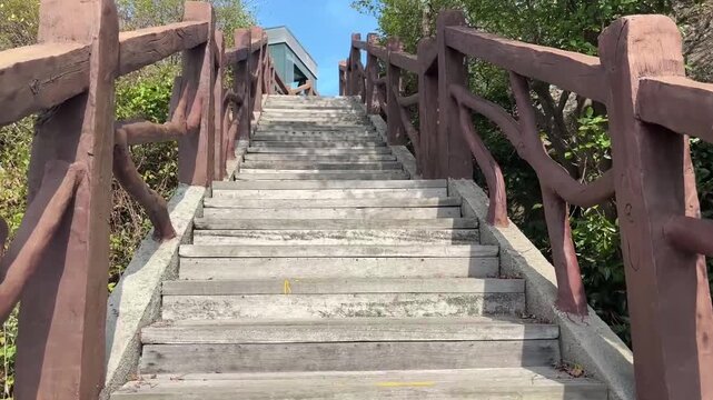 青空へと続く木製の階段を登る視点ショットの映像