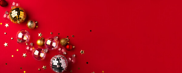 Festive Christmas ornaments on a red background.