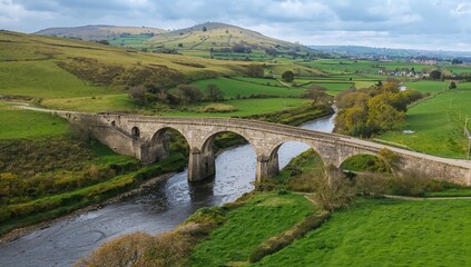 Arched stone bridge over water with lush greenery, urban density