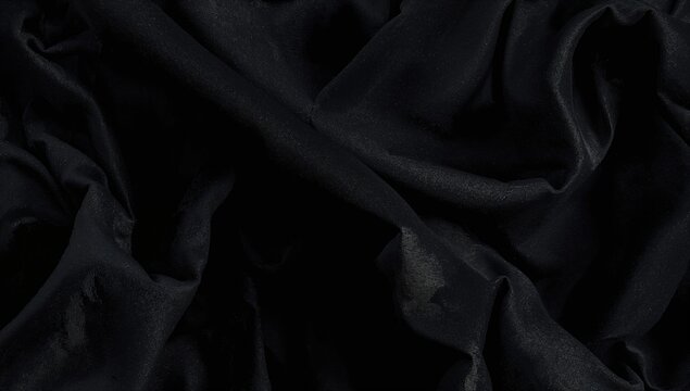 Close-up of slightly wrinkled black textured fabric with a subtle shine, suitable as a refined backdrop for photography or artistic endeavors