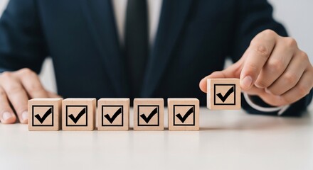 Obraz premium Business checklist concept with wooden checkmark blocks and hand selecting box, quality control success.