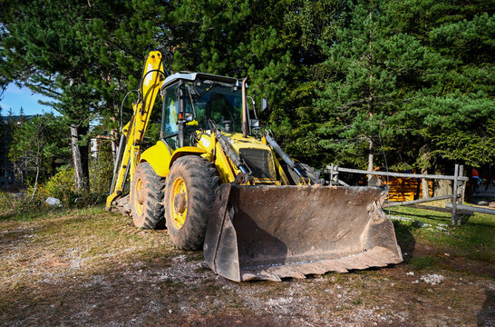 Bulldozer in the forest. Heavy machinery. Yellow construction bulldozer.