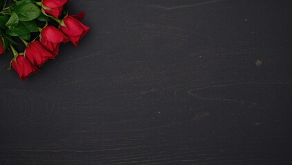 Red roses arranged on a dark wooden surface, ideal for a romantic gesture