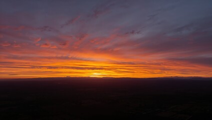 Obraz premium Sunset or sunrise with warm backlighting and a vivid panoramic sky. Timelapse style scene.