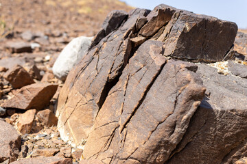 Large Fractured Rock Face with Deep Scratches and Mineral Veins in Desert Landscape