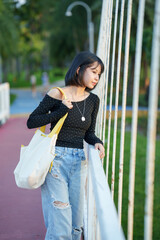 Fototapeta premium A woman is having fun walking in a park.