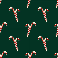 Seamless pattern with striped candy on green background. Christmas festive background. For textiles or holiday design, wrapping paper.