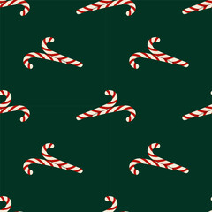 Festive seamless pattern with striped candy canes on dark green background. Christmas background. For wrapping paper, textiles or holiday design.