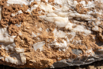 Abstract Texture of White Crystalline Rock Embedded in Rough Brown Earth
