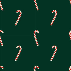 Simple seamless pattern with candy canes on green background. Christmas background. For gift wrapping, cards, backgrounds and covers.
