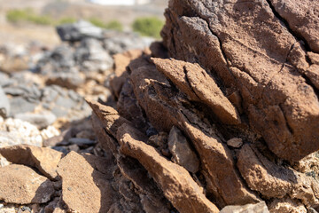 Jagged, Fractured Brown Rock Outcrop in Arid Desert Landscape