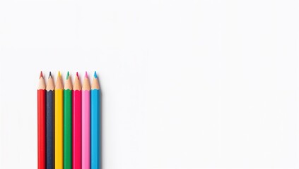 Fototapeta premium Vibrantly colored pencils arranged on a white backdrop, suitable for text placement