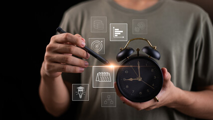 A person holding a classic alarm clock while using a stylus with floating icons of calendar, analytics, and target, symbolizing time management, strategic planning, project management