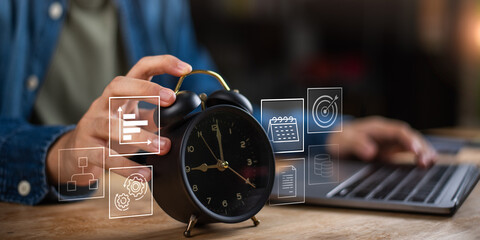 A hand holding a classic alarm clock with digital icons like progress charts, calendar, and target, symbolizing digital productivity, task scheduling, and effective time management in work settings.
