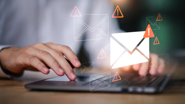 A person typing on a laptop with floating email icons, communication and email management, spam protection, modern messaging workflows in professional environments, business communication technology