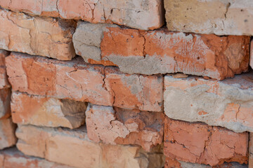 Weathered Brick Wall Stack With Cracks and Mortar Texture in Rustic Construction Setting