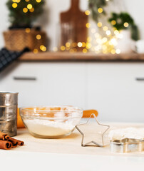 Christmas cooking. Flour, dough, cookie cutter to make Christmas gingerbread cookie on the table. Xmas baking at kitchen.