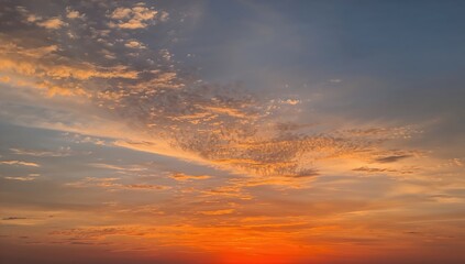 Fototapeta premium Clouds and orange sky, Vivid display of a majestic sunrise with soft, colorful clouds, ideal for scenic backgrounds.