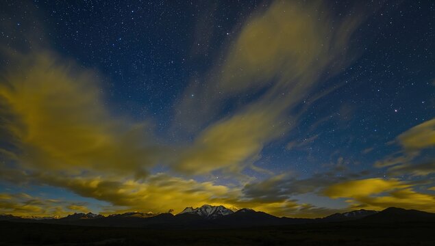 Beautiful sky displaying yellow hues above mountains, seasonal change