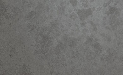 A detailed close-up of a dark grey, mottled surface with an organic, distressed texture, suggesting weathered stone or aged concrete, ideal for a rugged background