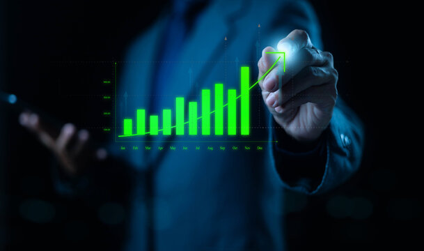 Businessman drawing glowing green growth chart on virtual screen, representing financial success, business analytics, data strategy, and economic performance.