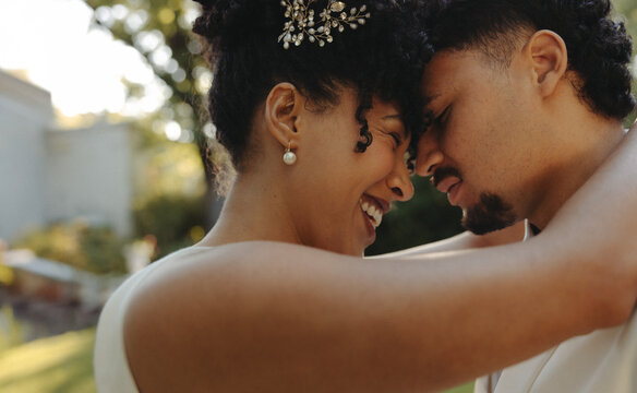 Loving couple sharing an emotional moment on their wedding day