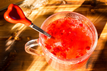 Homemade cranberry mors in transparent glass cup on rustic table. Organic berry drink rich in vitamins, healthy natural refreshment, detox and wellness concept. © Natallia Leanovich