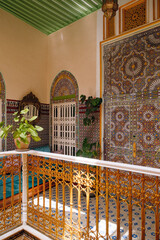 Ornate Moroccan courtyard in Tetouan with intricate tiles, arches, sunlight, and Islamic ornamentation, blending art and architecture.