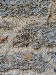 Naklejka premium Granite stone wall texture close-up detail of rough surface