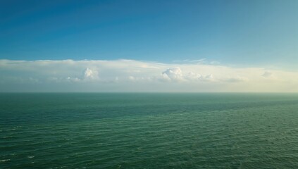 Obraz premium Emerald Ocean and Ivory Skies, seasonal change