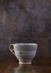 Traditional, handcrafted ceramic on wooden background. Soft focus. Copy space.	