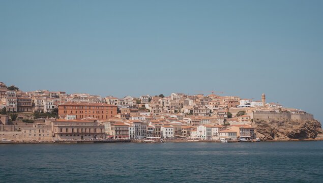 Picturesque view of a historic village by the sea with white buildings and stunning architecture