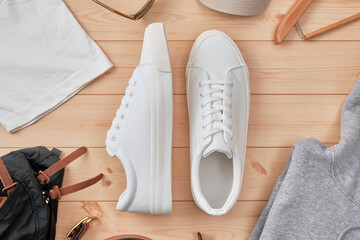 Sneakers and Accessories on Wooden Floor