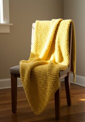 Yellow blanket draped over a wooden chair in a sunlit room.