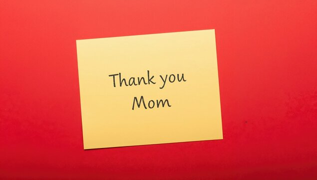 A yellow note placed on a bright red backdrop, conveying the heartfelt message Thank you Mom, symbolizes gratitude for maternal support.