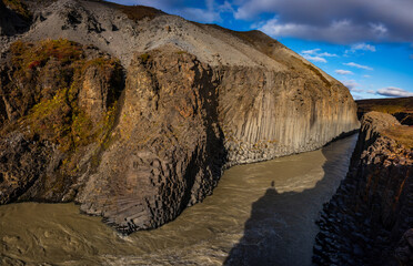 Studlagil Canyon in Iceland features striking basalt columns and a vibrant turquoise river. This natural landscape is ideal for hiking and photography, showcasing Iceland's unique geology.