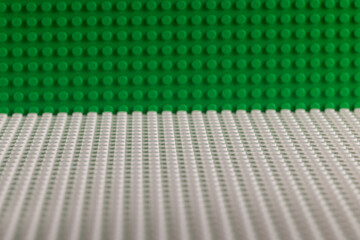 Obraz premium Green and White LEGO Baseplates Building Background Perspective