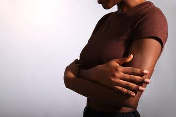 Nude beige manicured nails of afro woman in studio, copy space