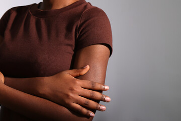 Nude beige manicured nails of afro woman in studio, copy space