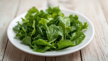 Salad leaves arranged on a plate atop a wooden table, healthy meal option, spring freshness