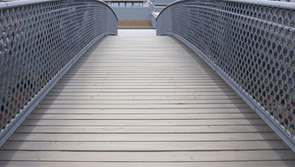 Wooden wheelchair ramp made for accessibility, featuring planks and metal lattice railing, promoting ease of movement