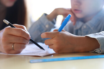 mom does homework with her child at home