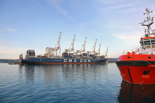 Tugboat and Container Ship Cma Cgm Moored at Adriatic Sea Port in Koper Slovenia
