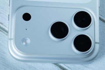  Macro shot  triple camera lenses on wooden surface